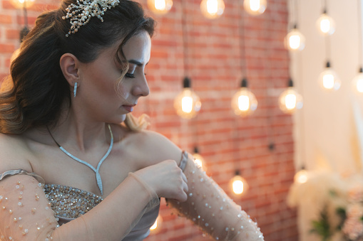 The new bride dances happily among the light bulbs. Young woman looking radiant among the glow of electric lights.