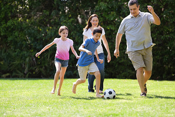 istock Children Playing Soccer With Parents 167201629