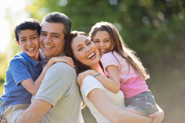 istock Loving Parents Carrying Children At Park 167201704
