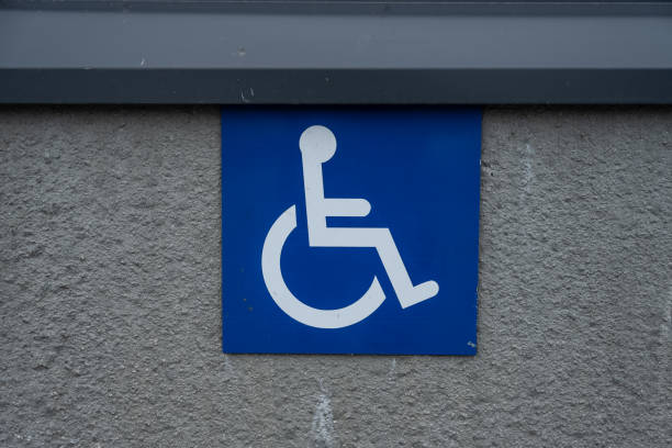 istock Handicap disabled parking sign by a store.. 1672036704