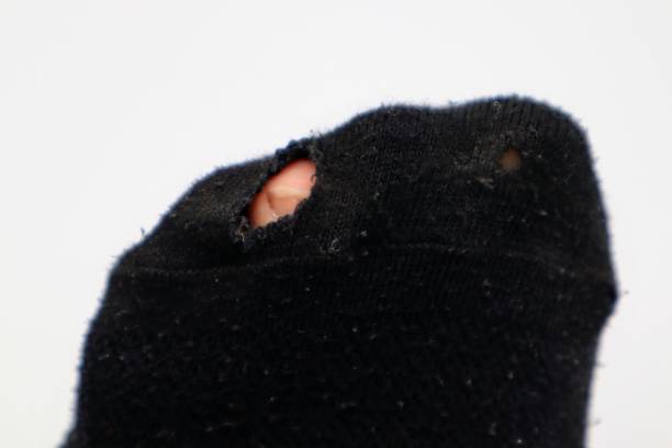 istock Close-up of socks with holes 1672039950