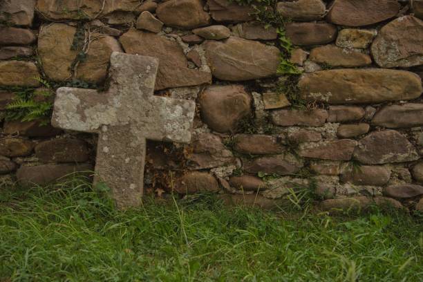 Scared atmosphere. Stone Cross at the Cemetery.
