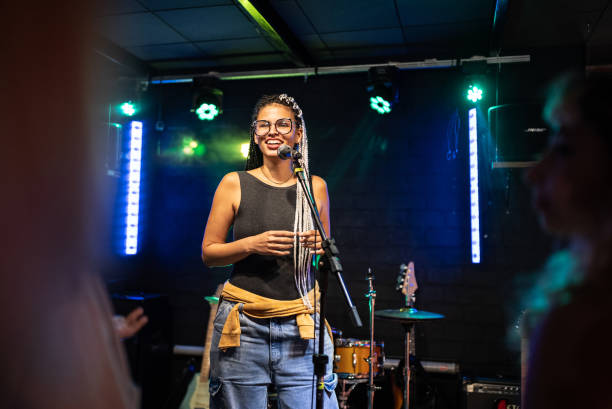 istock Young woman talking during stand-up comedy show 1672055311