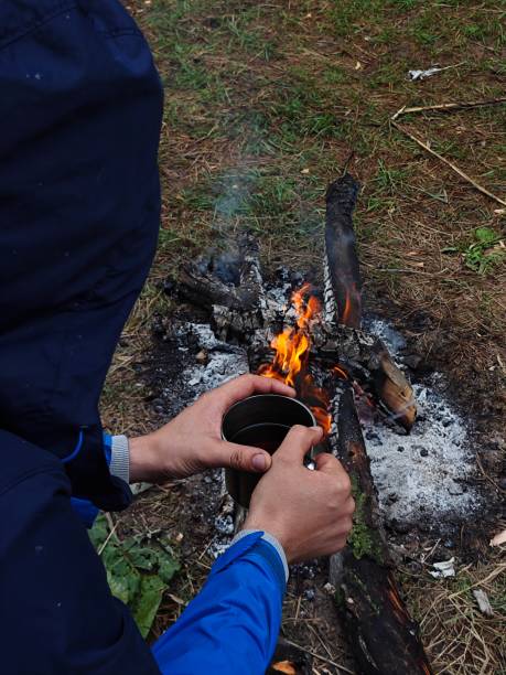 istock fisherman sitting by the fire 1672075628