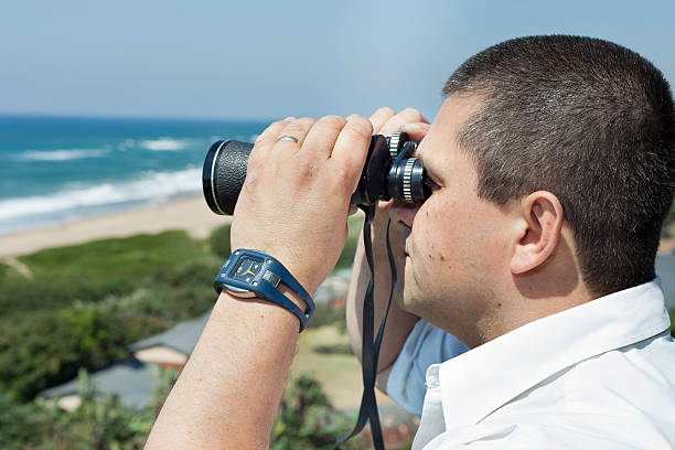 istock Man looking out at sea with binoculars 167208631