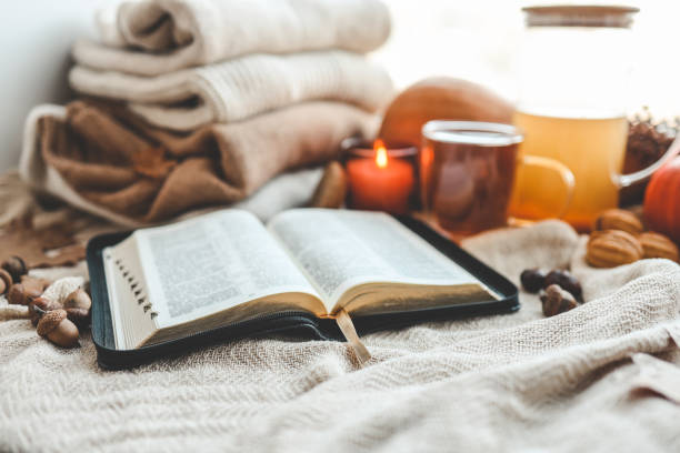 istock Open bible in autumn interior, good morning 1672090198