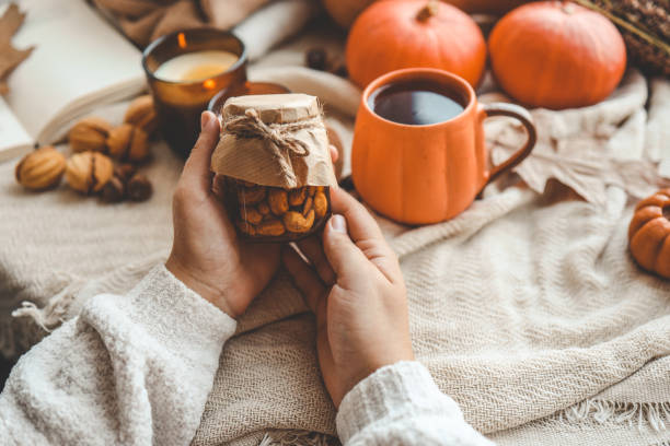 istock Jar of nuts with honey in hand 1672091775