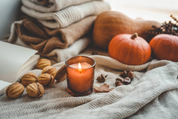 istock Burning candle in a cozy autumn interior 1672093339