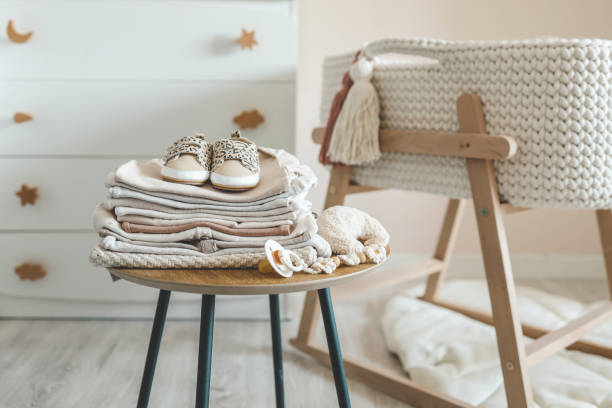 istock A stack of children's things on a wooden table in a children's interior 1672097663