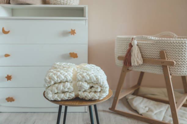 istock Handmade knitted blanket for a newborn in a nursery 1672097665