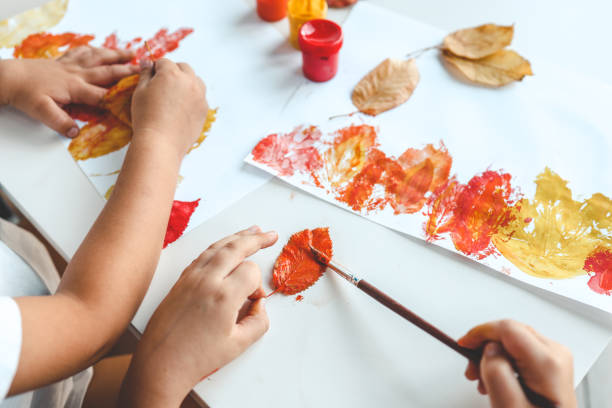 istock Children color the leaves and make a print, autumn creativity 1672107366