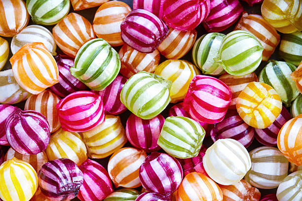 A picture of colorful candies with white striped patterns stock photo