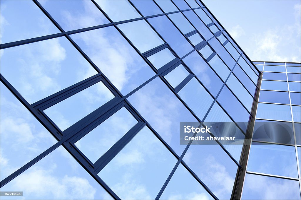 glass facade of office building glass facade of office building with reflections of clouds and blue sky Abstract Stock Photo