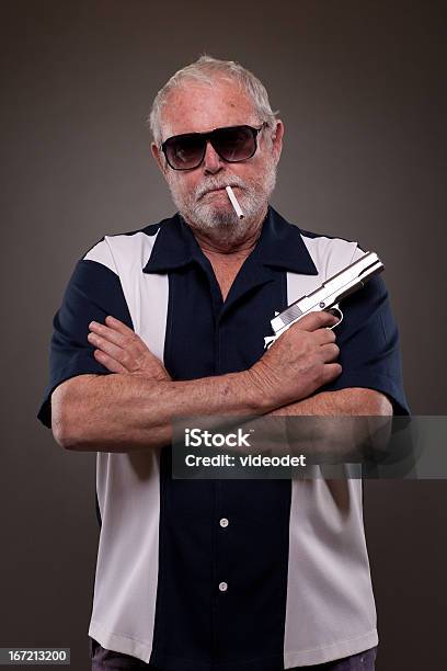 Man Smoking A Cigarette And Holding Handgun Stock Photo - Download Image Now - 60-69 Years, Addiction, Adult