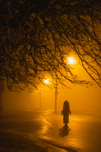 Silhouette of woman on street