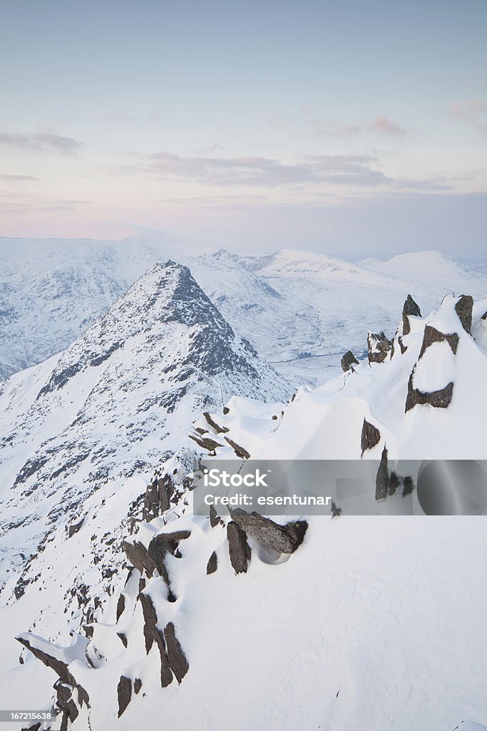 Tryfan Tryfan, one of the most impressive mountains in UK rises above the snow covered landscape in Snowdonia National Park. Mountain Stock Photo