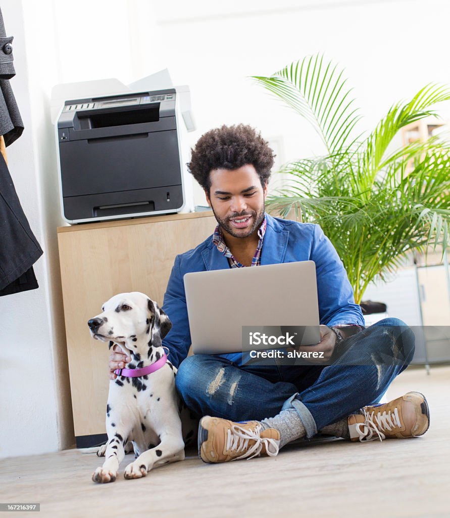 Young entrepreneur and his pet working Start up culture! Go to work and even bring your dog! Dog Stock Photo