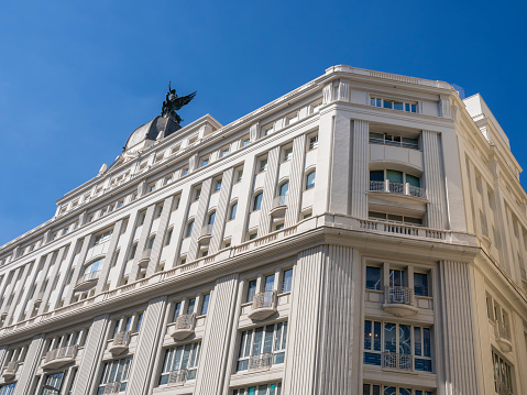 Madrid, Spain, September 8, 2023: detail of office building on the central Gran Via street. Main commercial area of the cit