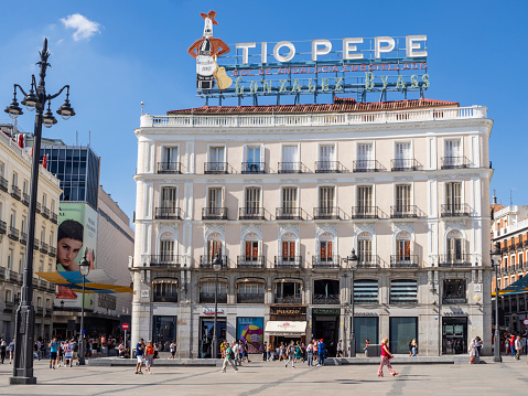 Madrid, Spain, September 8, 2023: partial view of Puerta del Sol square, emblem and main commercial and tourist area of the city. Detail of the famous Tío Pepe advertisement