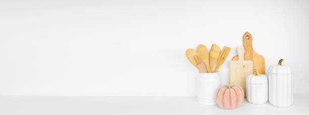 istock Autumn theme kitchenware, utensils and decor on a wood shelf banner background 1672177544