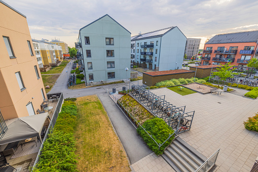 Sweden. Uppsala. 09.10.2023. Beautiful view of architecture of modern residential buildings with recreation area on playground and parking for bicycles.