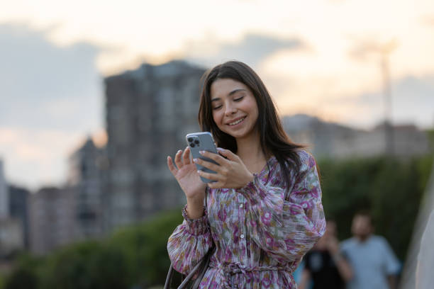 istock Well-dressed young woman is checking mails on portable device. 1672197080
