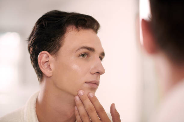 istock Man Applying Brightening Lotion 1672200314