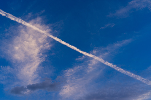 Contrails over blue sky.