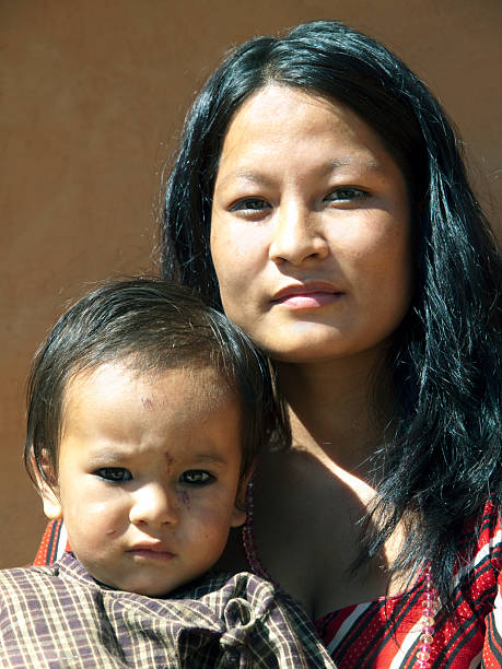 Portrait of Nepalese woman with her son Portrait of Nepalese woman with her son. The child is 2 years old. Nepal, near Nagarkot. nagarkot photos stock pictures, royalty-free photos & images