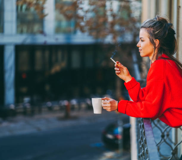 istock Relaxed woman smoking at the terrace 1672273907