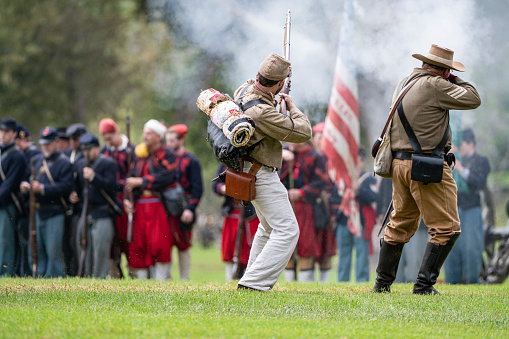 Huntington Beach, CA, USA - September 2, 2023: Confederate soldiers fire on Union troops  during a  civil war reenactment at the Huntington Beach Historical Society 30th annual Civil War Days Living History Event in Huntington Beach Central Park.