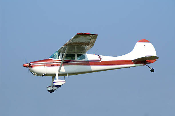 istock private airplane Cessna 170A flying in clear blue sky 167230130