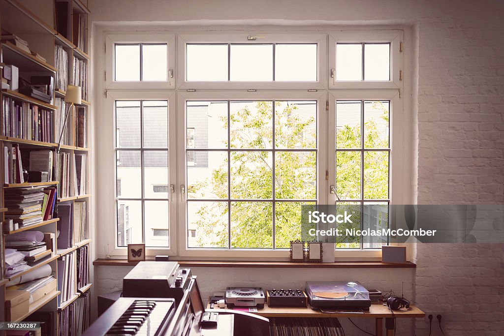 Window into the Music Room Large multi-panel casement window illuminating a lived-in music room. Window Stock Photo