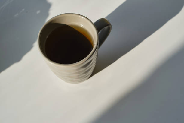 istock Cup with hot tea or coffee on a light background. Place for text. Warmth and comfort 1672314342