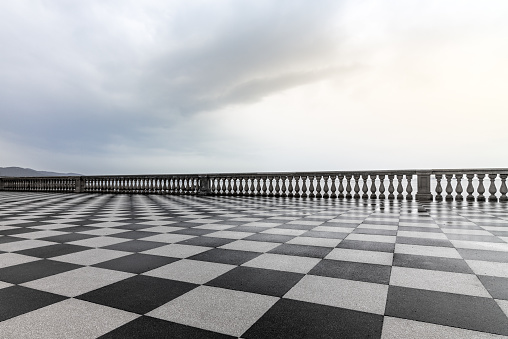 The reflection of the baluster in the rain puddles on the Terrazza in Livorno, Italy