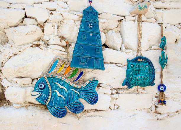 istock Fishes with evil eye beads wall hanging, white background wall. 1672331818
