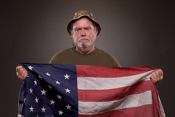 istock Vietnam Veteran holding American flag 167235225