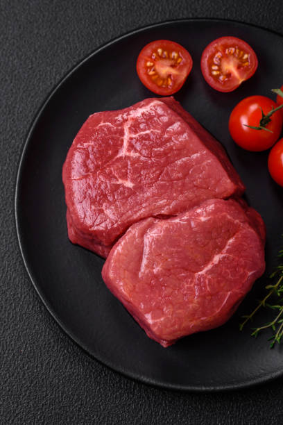 istock Raw fillet steak mignon beef with salt, spices and herbs 1672356036