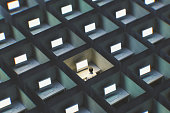 Surreal image of office cubicles with man working late