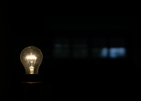 close-up of a lighted bulb in the dark
