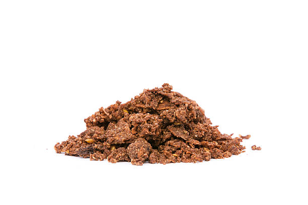 Organic Cacao Crunch Cereal Side view of a pile of organic cacao crunchy cereal on white background. Superfood. Reschi stock pictures, royalty-free photos & images