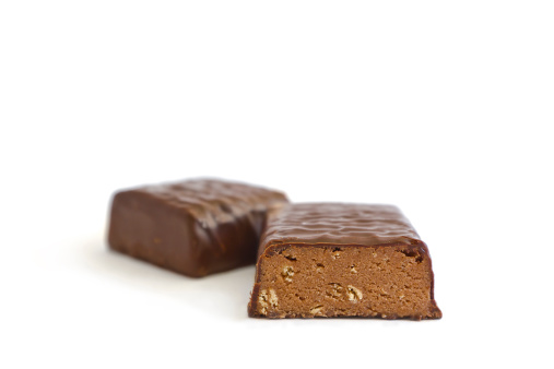 Side view of protein chocolate bar in two pieces. Isolated on white.