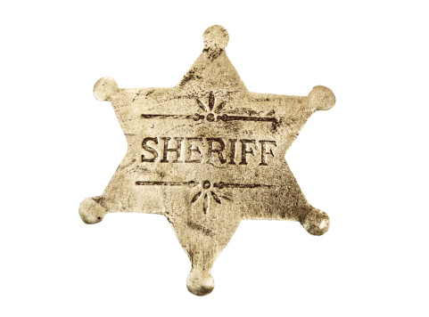 An old and worn antique six star sheriff badge with a clipping path.