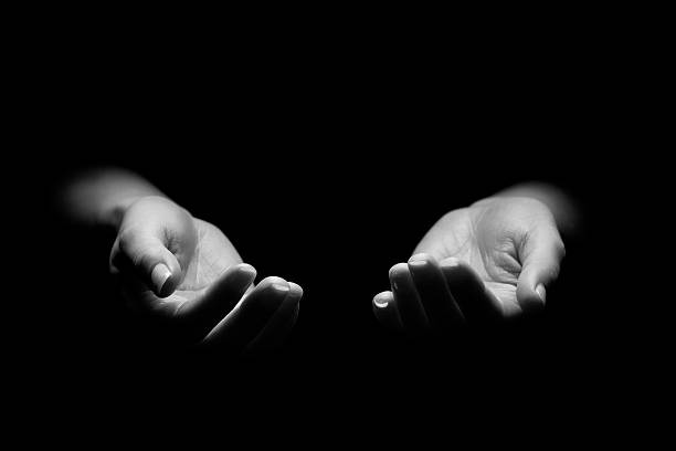 Hands Reaching Out Woman begging with outstretched hands. Hands reaching out. Black and white. pleading photos stock pictures, royalty-free photos & images