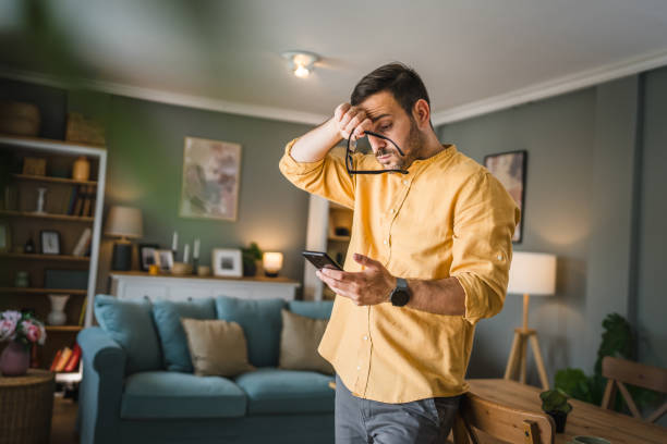 istock One adult man with eyeglasses at home use mobile phone have problem 1672438185