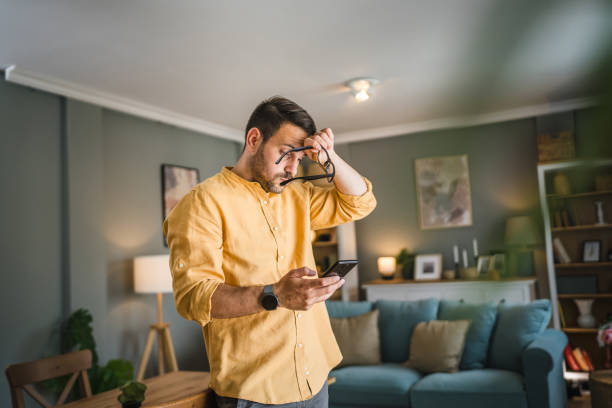 istock One adult man with eyeglasses at home use mobile phone have problem 1672439842