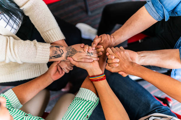 istock Close-up of a team holding hands 1672441449