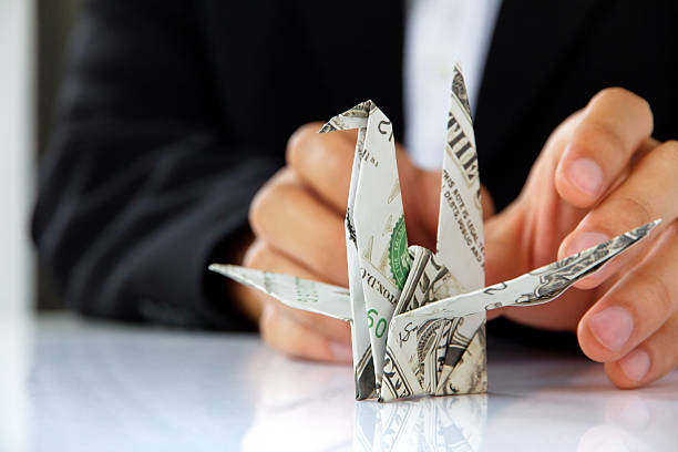 istock origami paper cranes, money concept 167244204