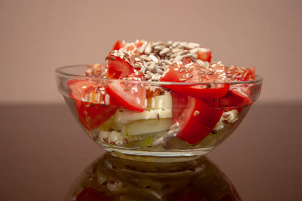 Salad from tomatoes and cucumbers with seeds.