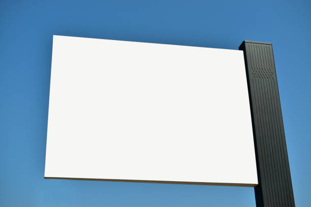 istock Low angle view of blank billboard with blue vibrant sky at background 1672456427